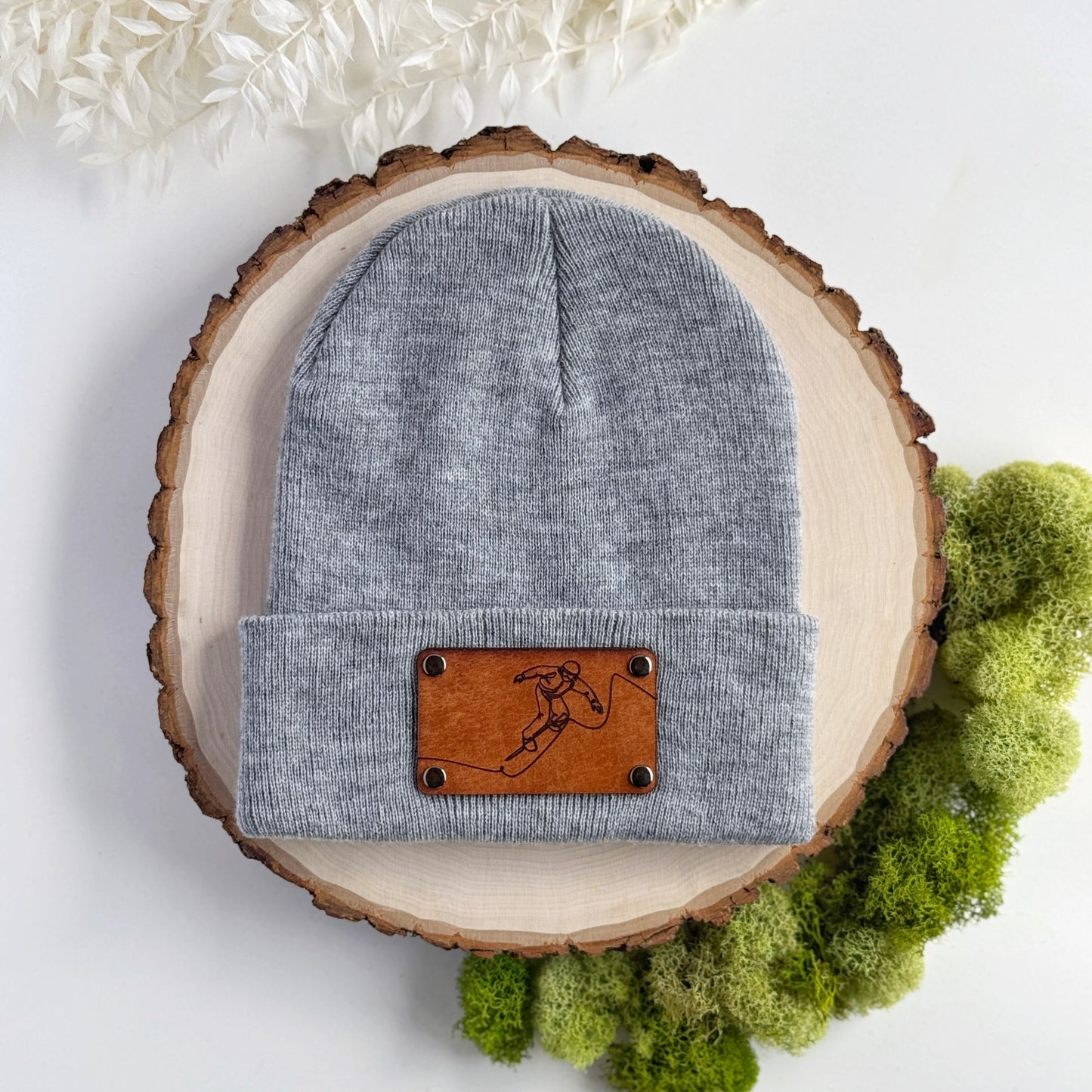 Snowboarder beanie with snap on/off leather patch