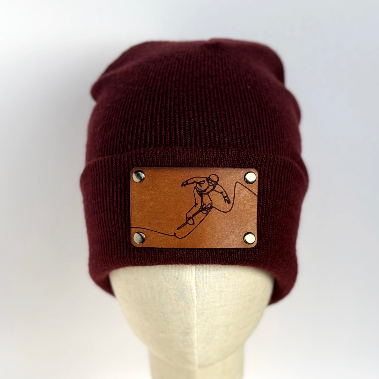 Snowboarder beanie with snap on/off leather patch